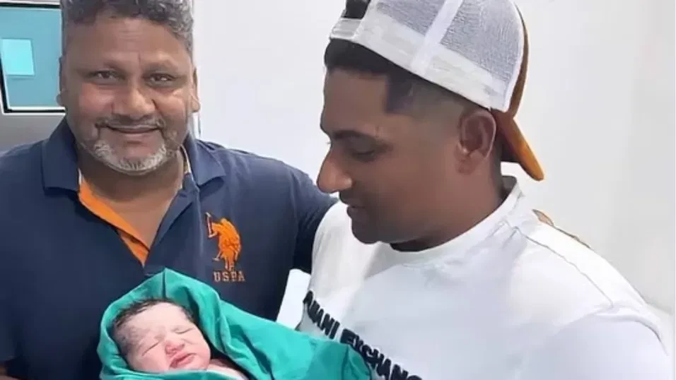 Sarfaraz Khan with his child.