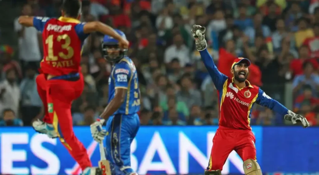 RCB players celebrate after dismissing Sanju Samson for 5 runs.