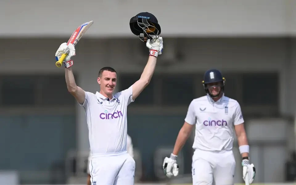 Harry Brook of England raises his bat as he leaves the field after his triple century.