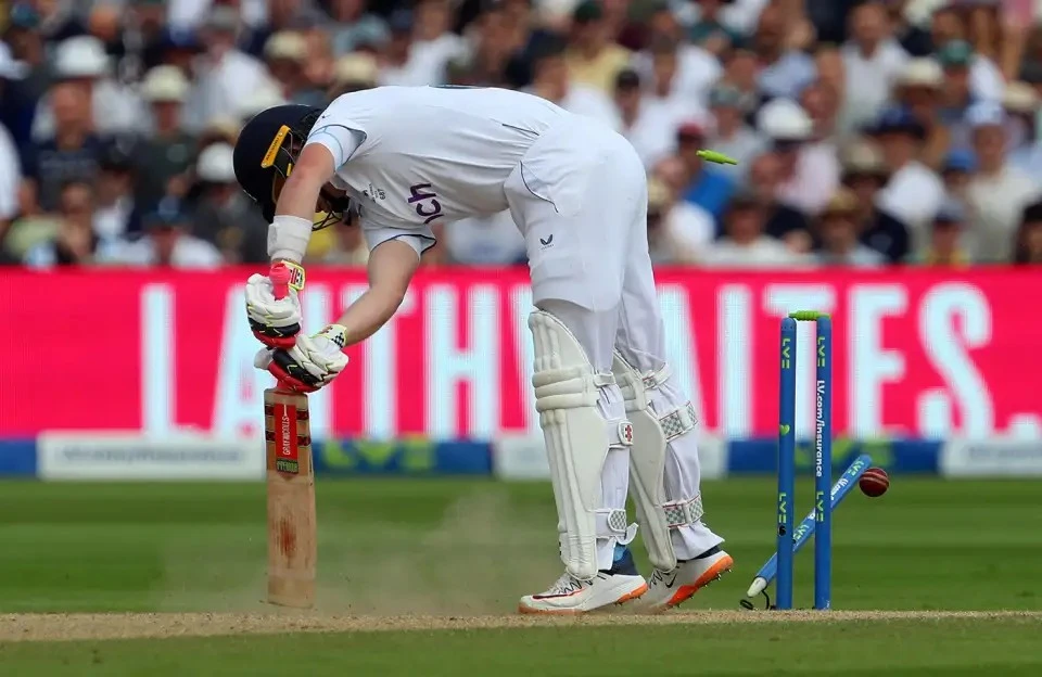Ollie Pope of England is bowled by Pat Cummins of Australia during the match.