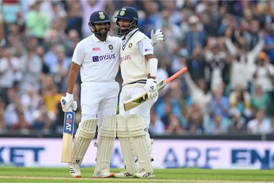 Cheteshwar Pujara congratulates Rohit Sharma with his century.