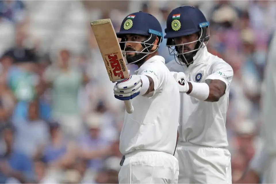 Virat Kohli raises his bat after another half-century.