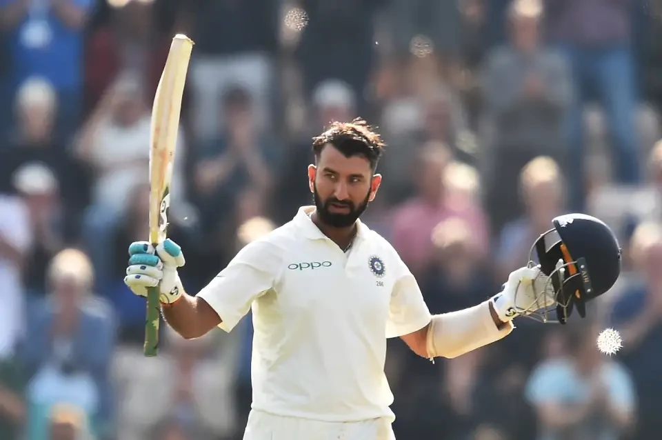 Cheteshwar Pujara celebrates his century.