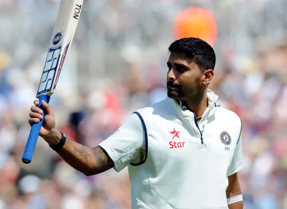 Murali Vijay raises his bat in celebration of his half-century.
