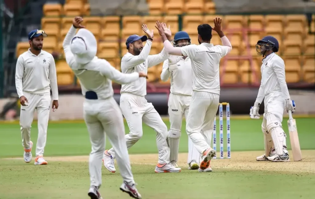 Madhya Pradesh players celebrate after dismissing Arman Jaffer for 26 runs.