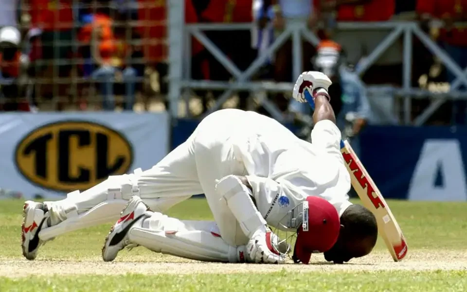 Brian Lara kisses the pitch after breaking records.