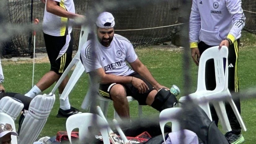 Rohit Sharma has an ice pack strapped to his leg after being struck.