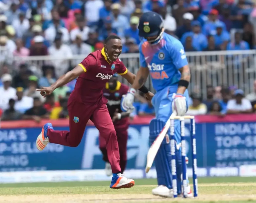 Dwayne Bravo celebrates after dismissing Virat Kohli for 16 runs.