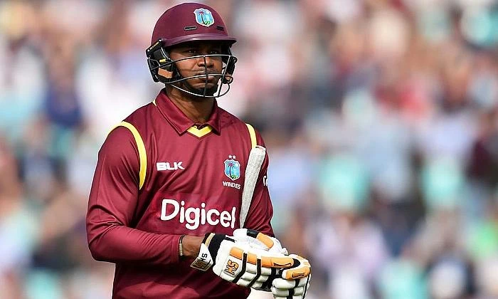 Samuels walks back to the dugout after losing his wicket.