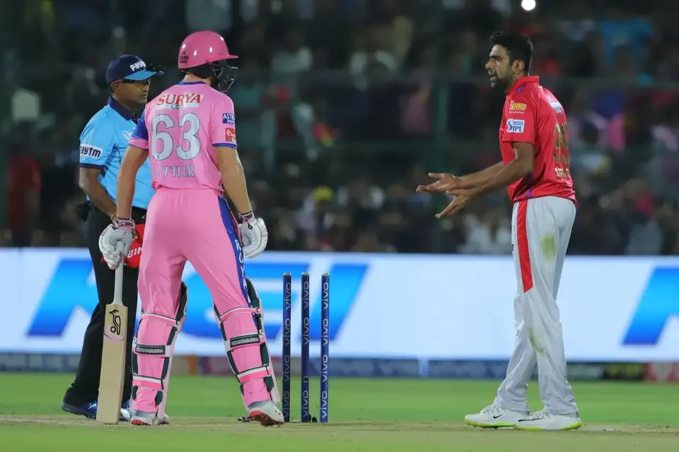 Ravichandran Ashwin and Jos Buttler on the field during the game.