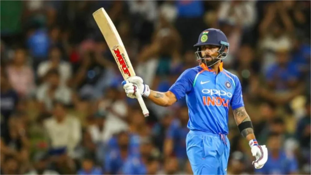 Virat Kohli during a match wearing a uniform with the OPPO logo.
