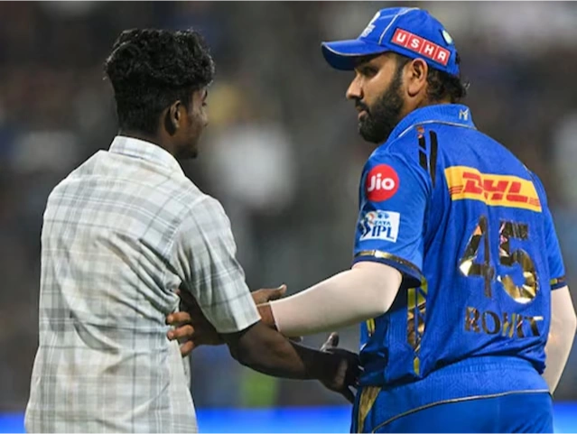 Rohit gets scared as a fan invades the pitch to meet him.