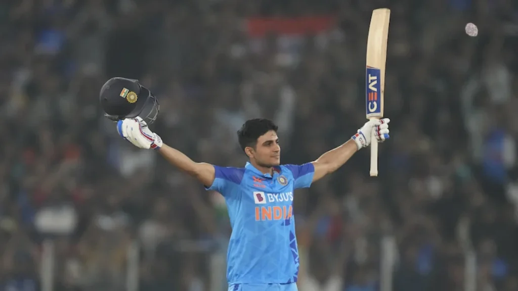 Gill celebrates after completing his century.