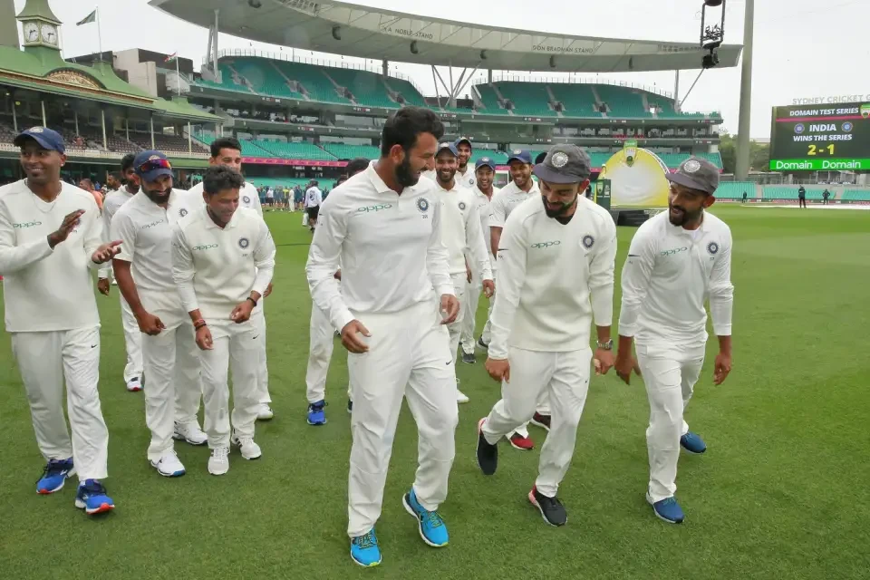 The India team celebrate on the field.