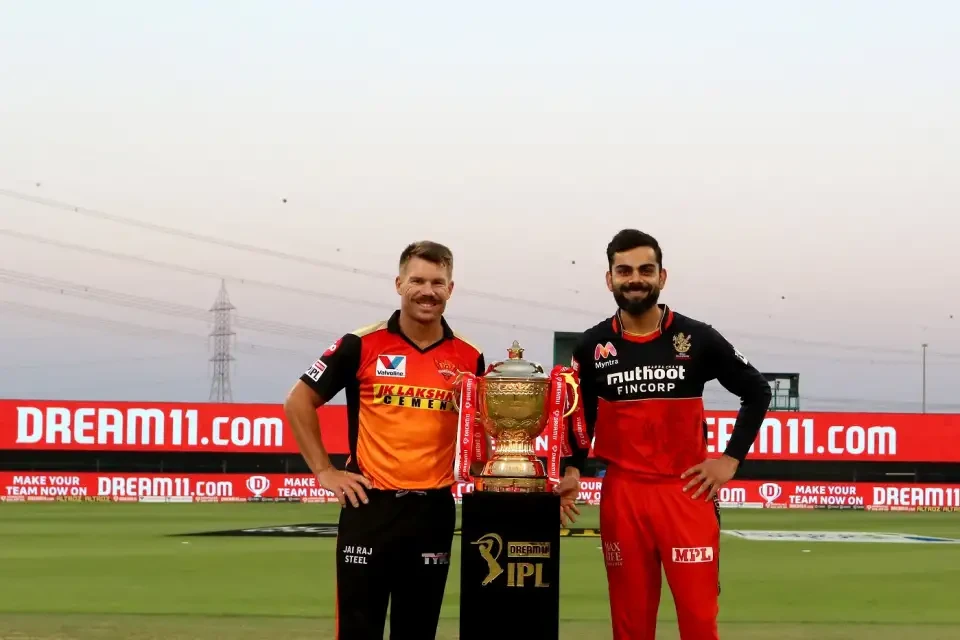 Virat Kohli posing with the IPL trophy.