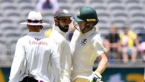 Virat Kohli and Tim Paine exchange some words on the field.